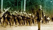 A screen shot of the mannequin-soldier trying to join a large group of marching soldiers