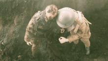 Screen shot of the mannequin-soldier being pulled out of the muddy shell crater.