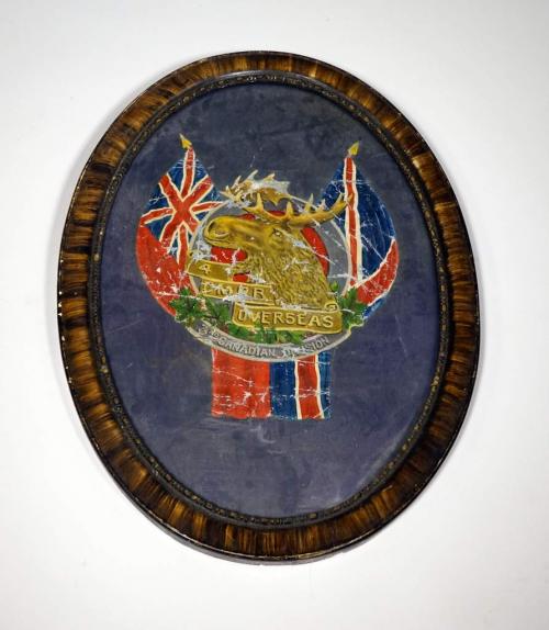 An oval, framed picture with a moose head with Union Jack imagery.