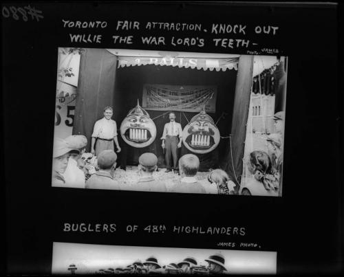 A black and white photograph of a crowd gathered in front of a midway game.