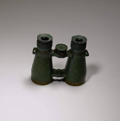 A pair of green metal binoculars.