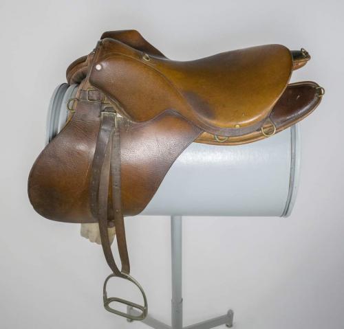 An English-style, brown leather saddle.