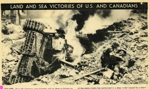 A black-and-white photograph of a medic attending to a soldier near a burning tank.