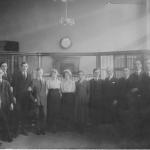 A black and white photograph of Byron Cooper Sisler posing with fellow bank  employees.