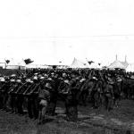 A black and white photograph of a group of soldiers forming up into rows  during training.