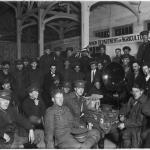 A black and white photograph of Canadian soldiers sitting around a phonograph.