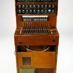 A portable switchboard in a fold-up wooden case.