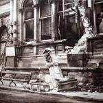 A photograph of the bombed Royal Hotel with debris on the street.