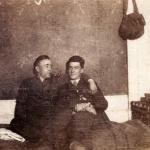 A black-and-white photograph of Byron Cooper Sisler sitting with a fellow soldier.