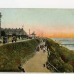 A colourized postcard depicting the harbour of the seaside town of Folkestone, England.