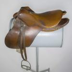 An English-style, brown leather saddle.