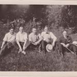 A black-and-white photograph of Byron Cooper Sisler sitting with a group of friends.