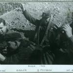 A black-and-white photograph of four soldiers in a dugout.